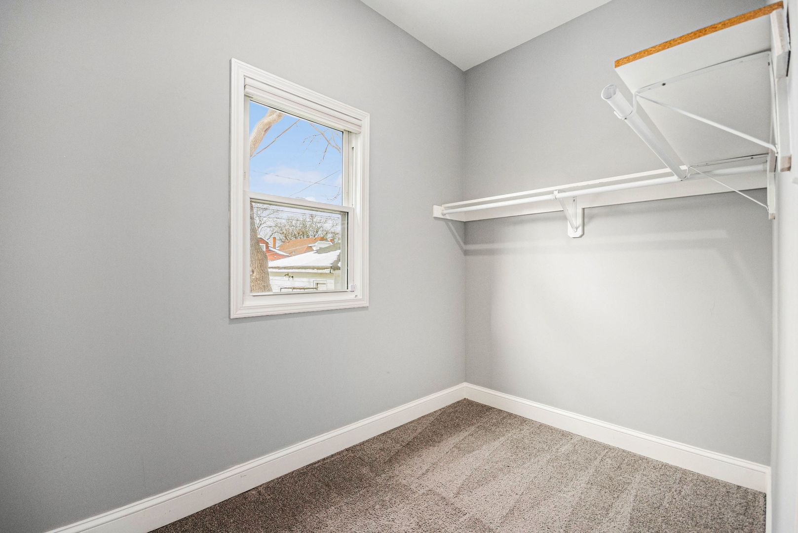 1702 North Meade Avenue, Unit 1 Chicago, IL 60639 - Photo 7 of 14 a view of an empty room with a window
