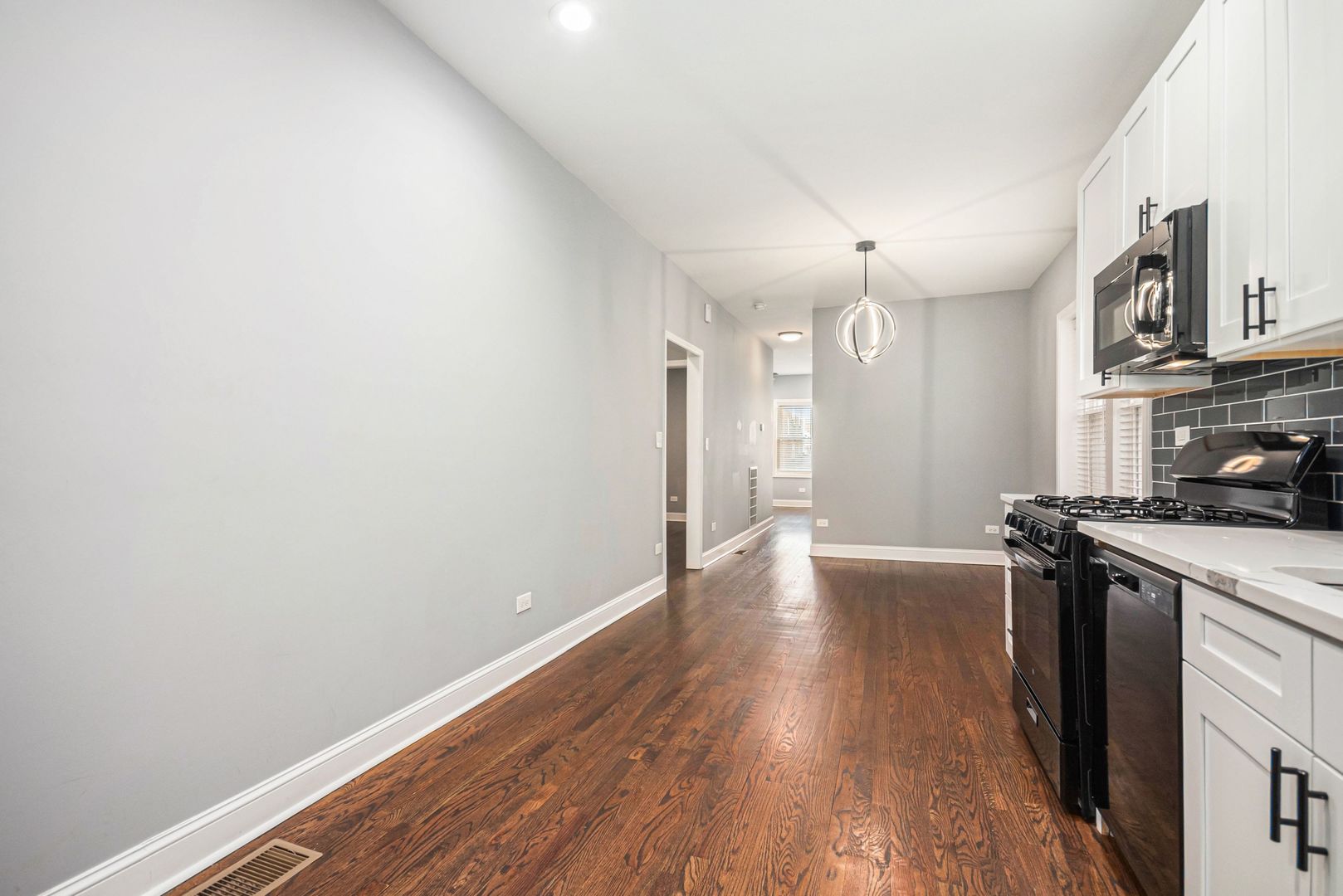 1702 North Meade Avenue, Unit 1 Chicago, IL 60639 - Photo 9 of 14 a view of a kitchen with a stove wooden floor and a kitchen