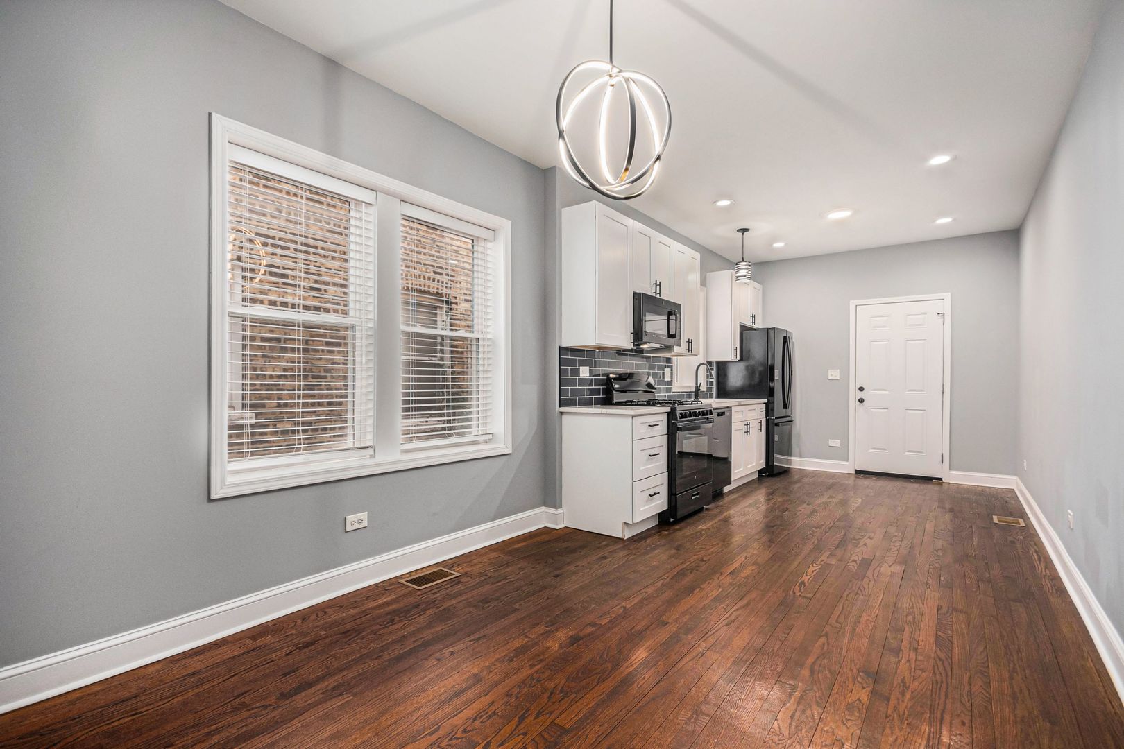 1702 North Meade Avenue, Unit 1 Chicago, IL 60639 - Photo 10 of 14 a view of kitchen with granite countertop stainless steel appliances cabinets a window and a chandelier
