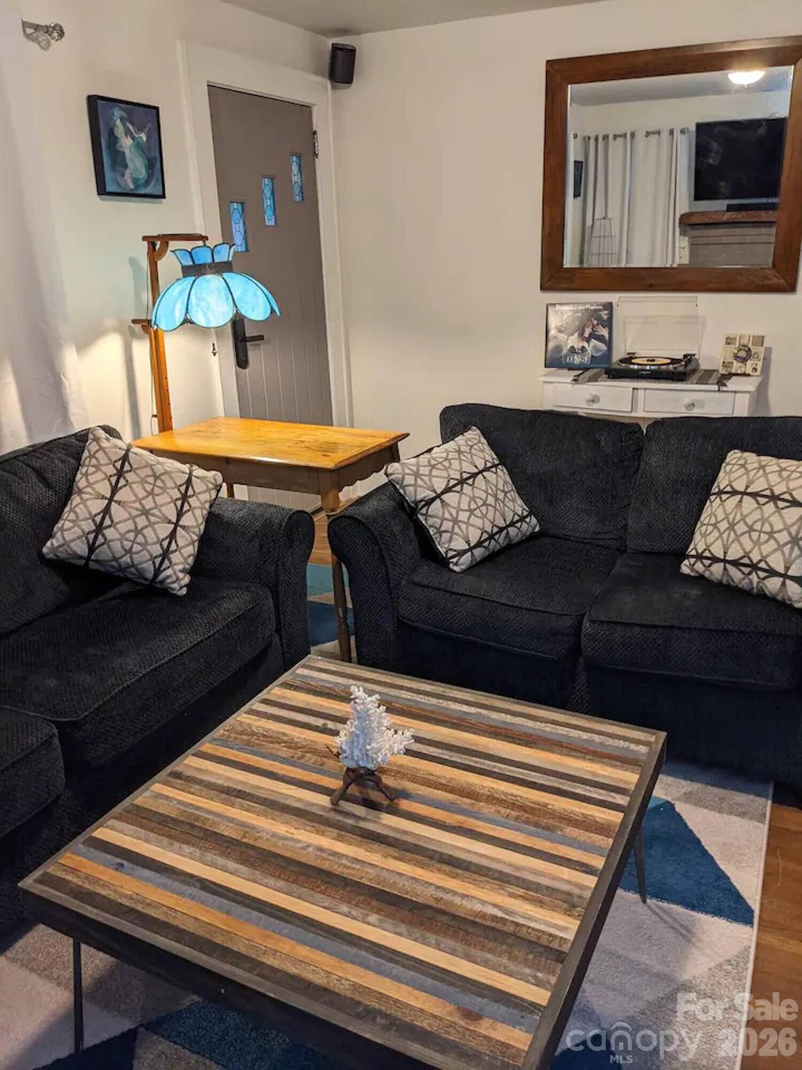 4033 West Tyvola Road Charlotte, NC 28208 - Photo 11 of 48 a living room with furniture and wooden floor