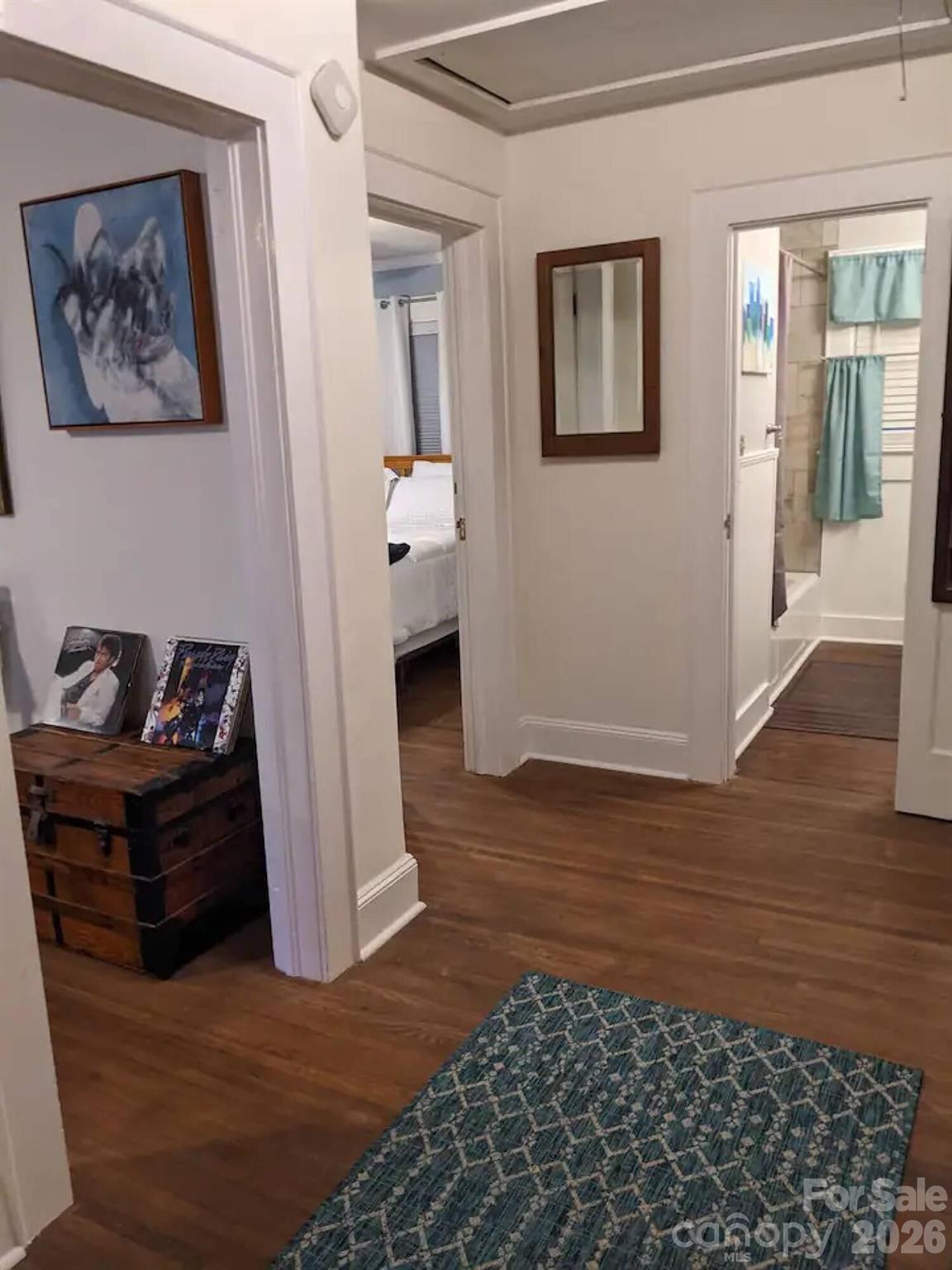 4033 West Tyvola Road Charlotte, NC 28208 - Photo 15 of 48 a view of a hallway with wooden floor and a bookshelf