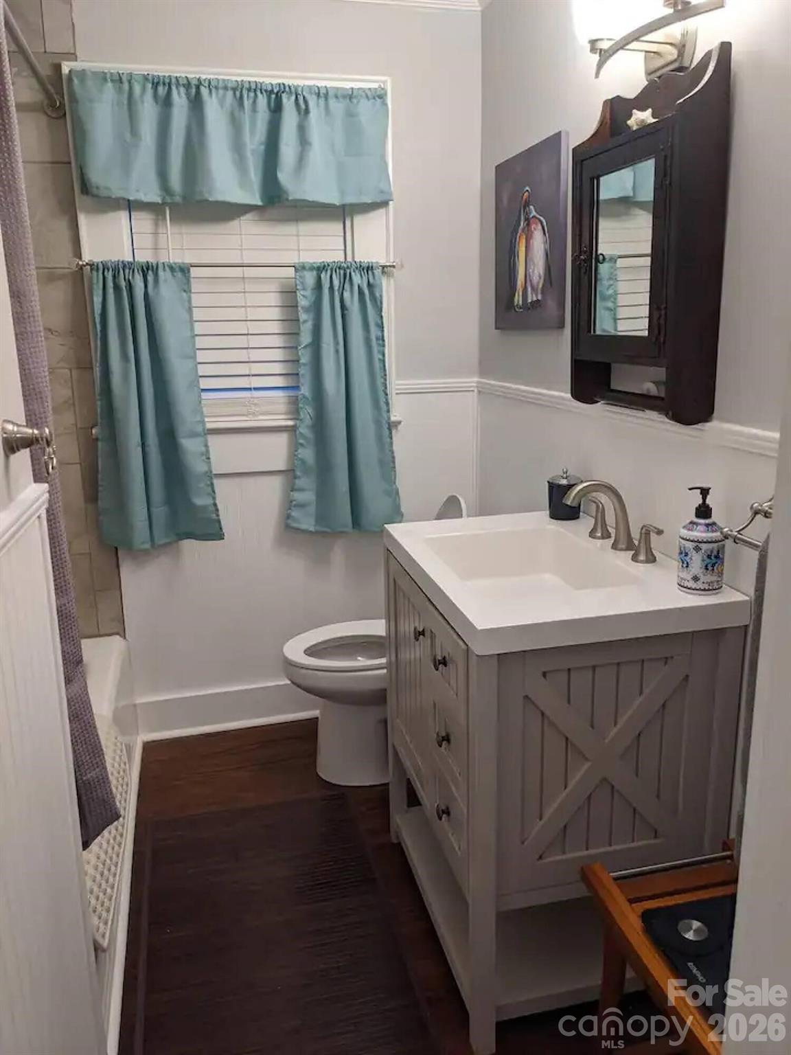 4033 West Tyvola Road Charlotte, NC 28208 - Photo 26 of 48 a bathroom with a sink toilet and a mirror