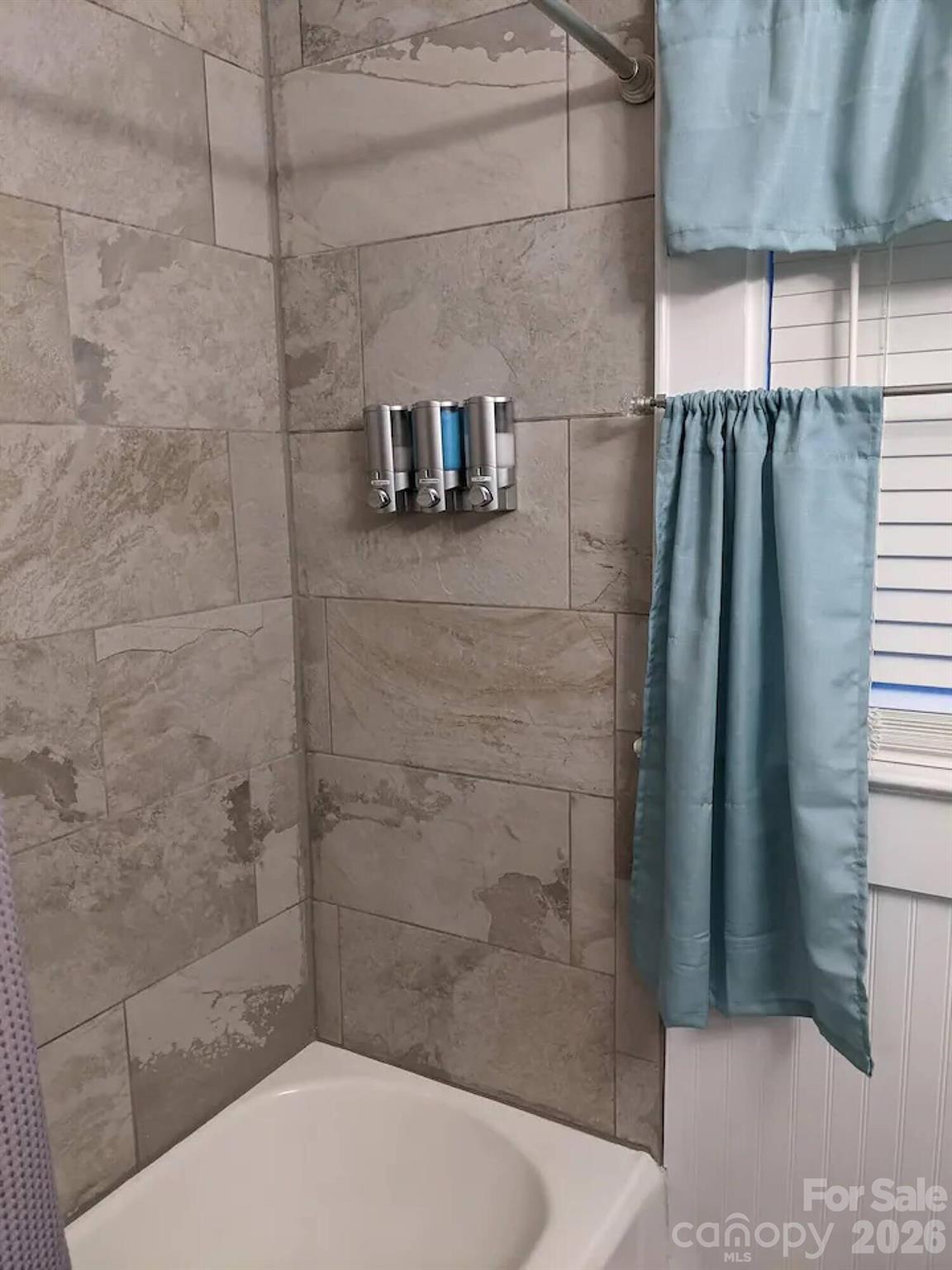 4033 West Tyvola Road Charlotte, NC 28208 - Photo 28 of 48 a bathroom with a shower and a toilet