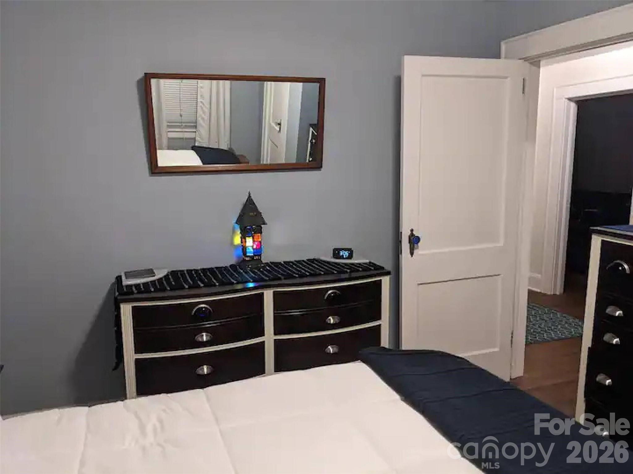 4033 West Tyvola Road Charlotte, NC 28208 - Photo 29 of 48 a bed room with a bed and a television