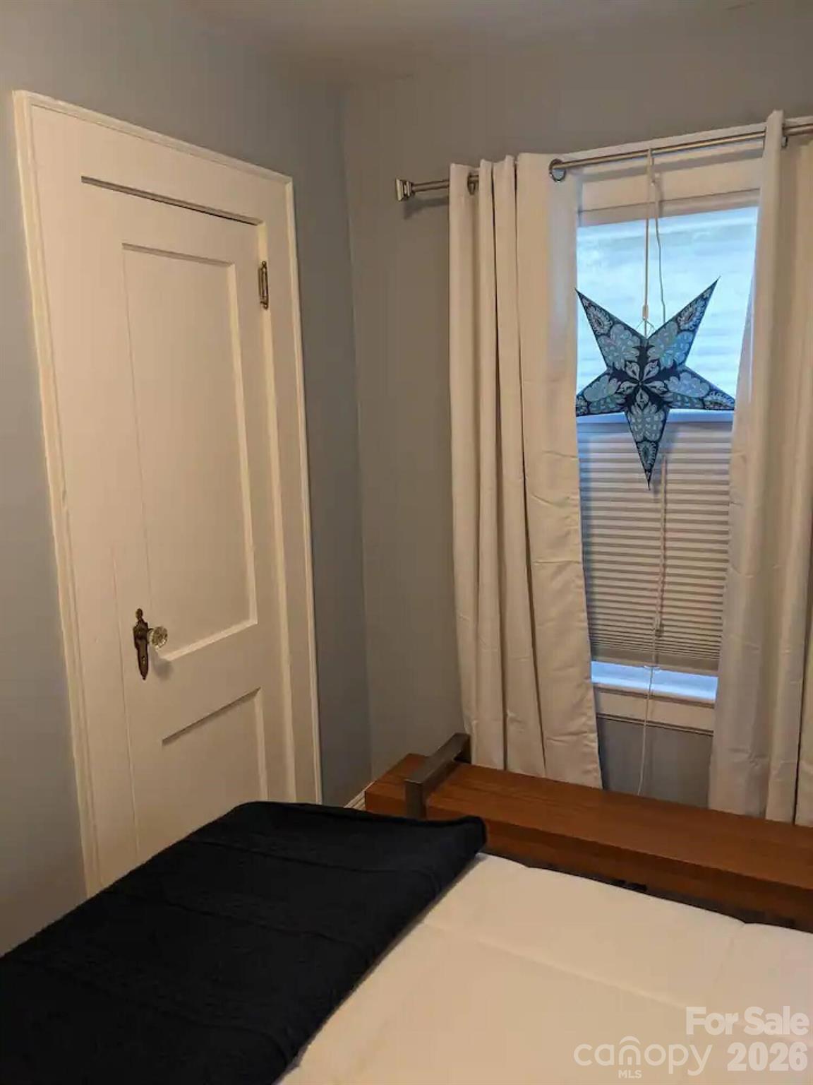 4033 West Tyvola Road Charlotte, NC 28208 - Photo 30 of 48 a bedroom with a bed and a window