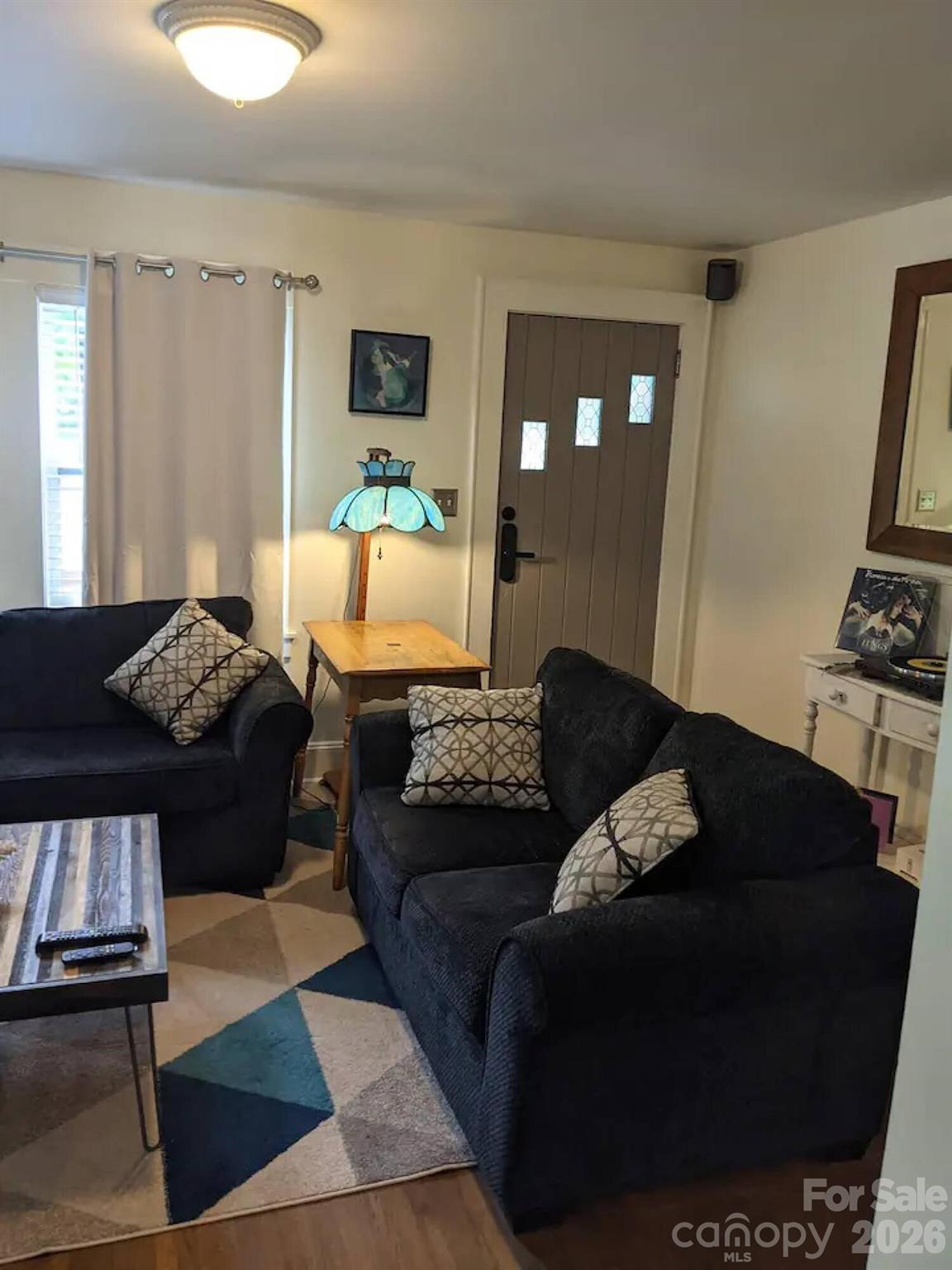 4033 West Tyvola Road Charlotte, NC 28208 - Photo 3 of 48 a living room with furniture rug and window
