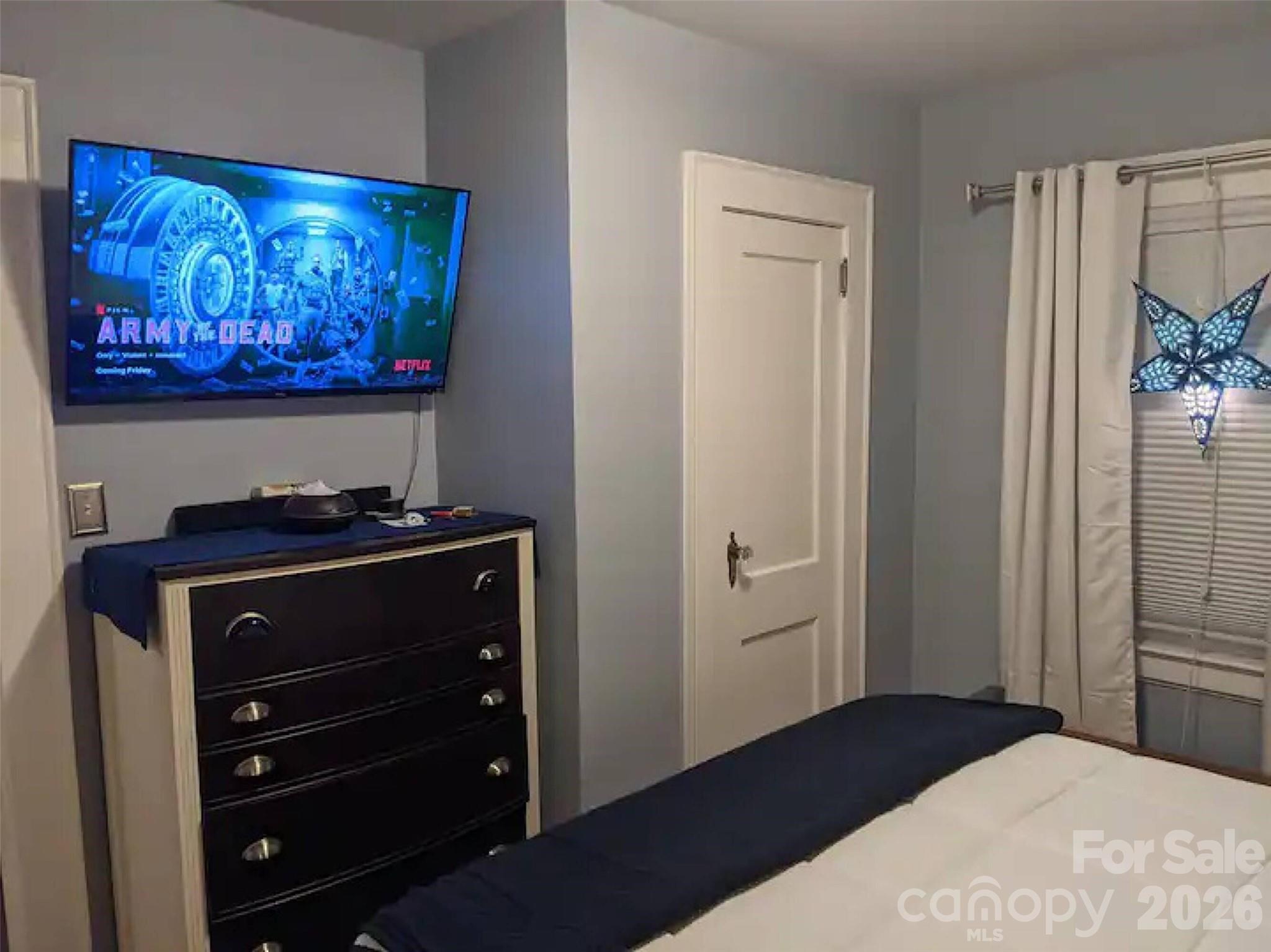 4033 West Tyvola Road Charlotte, NC 28208 - Photo 31 of 48 a bedroom with a bed and painting on the wall