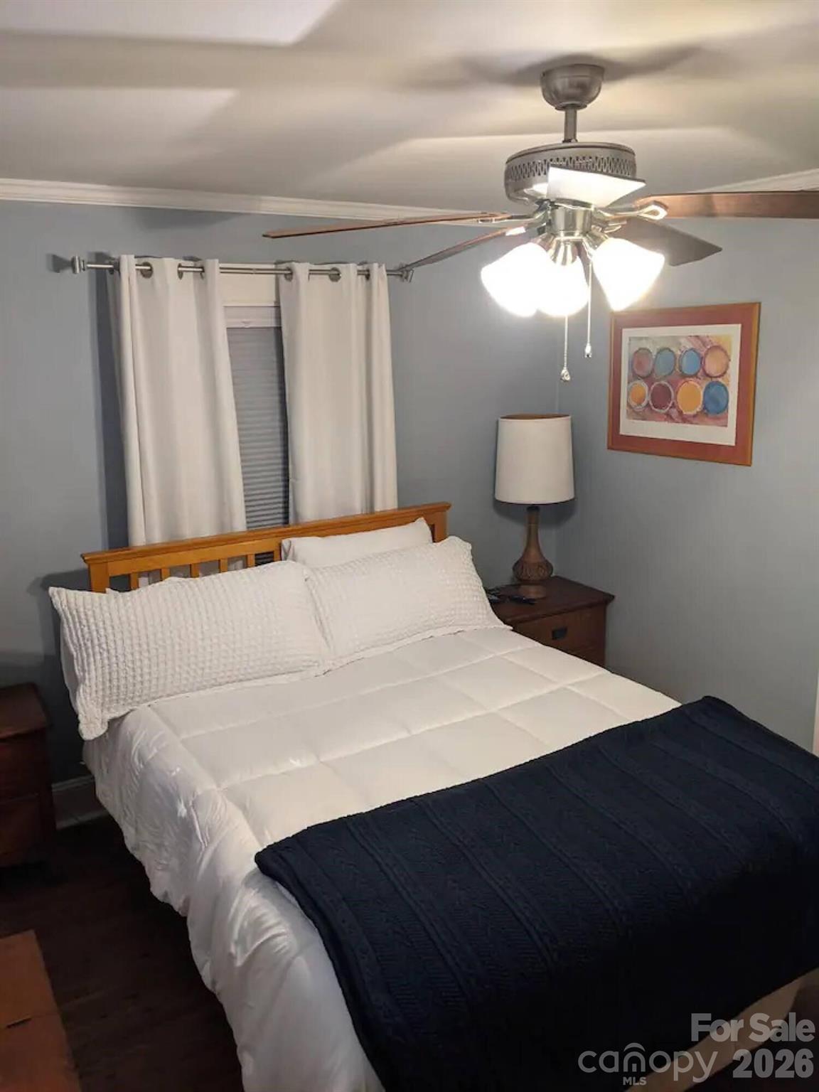 4033 West Tyvola Road Charlotte, NC 28208 - Photo 36 of 48 a bedroom with a bed and a chandelier