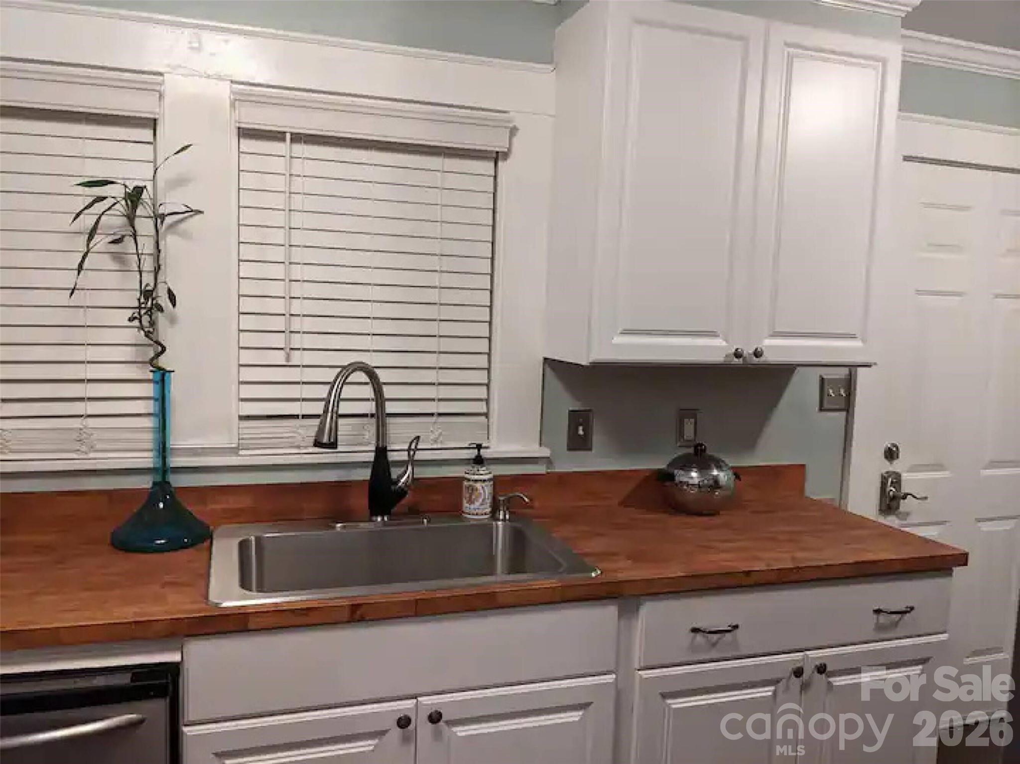 4033 West Tyvola Road Charlotte, NC 28208 - Photo 39 of 48 a kitchen with a sink and cabinets