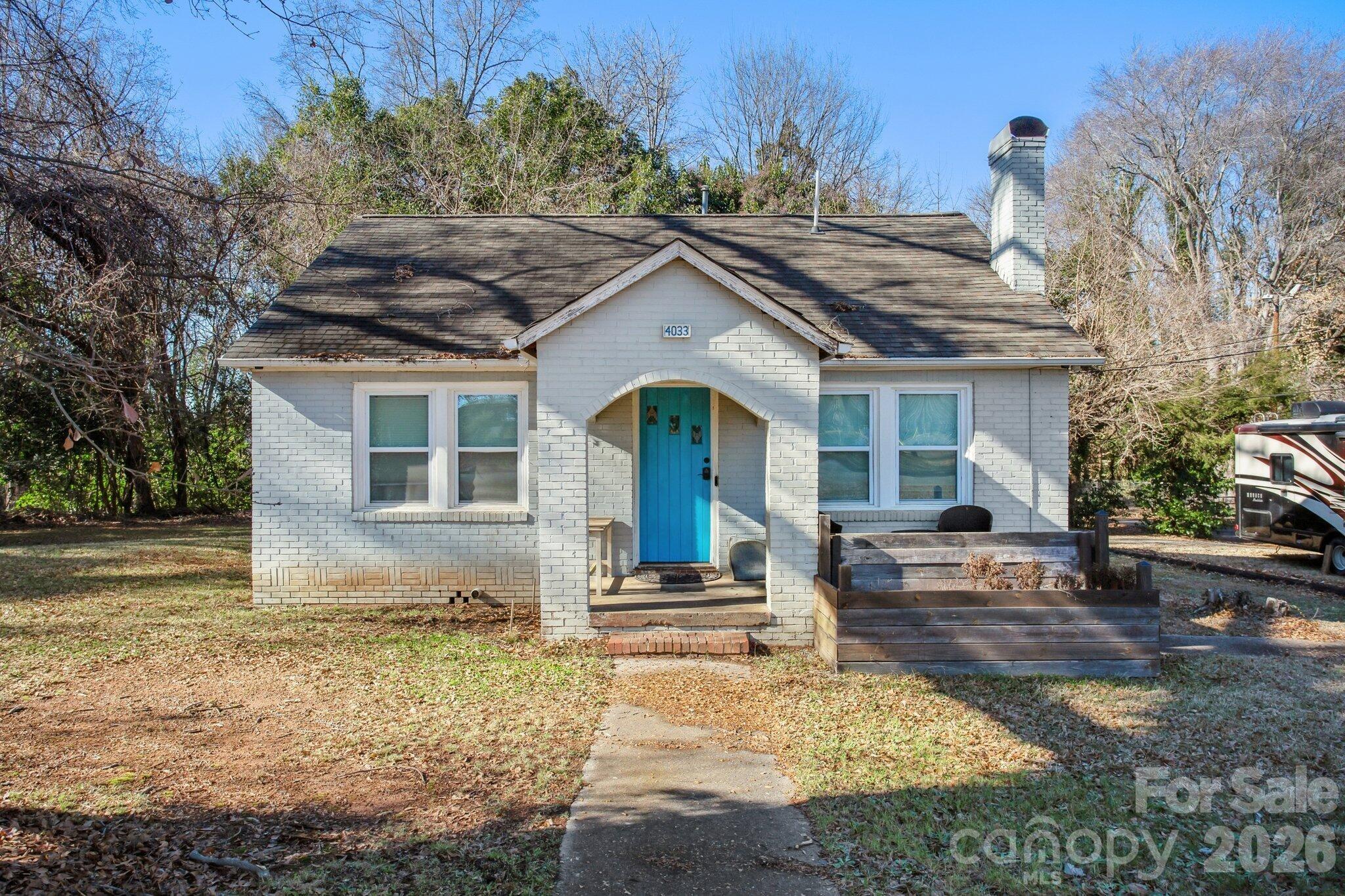 4033 West Tyvola Road Charlotte, NC 28208 - Photo 45 of 48 a front view of a house with a yard