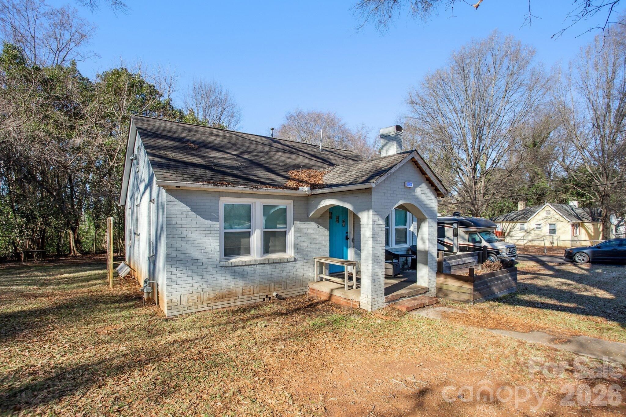 4033 West Tyvola Road Charlotte, NC 28208 - Photo 46 of 48 a view of a house with a yard covered in snow