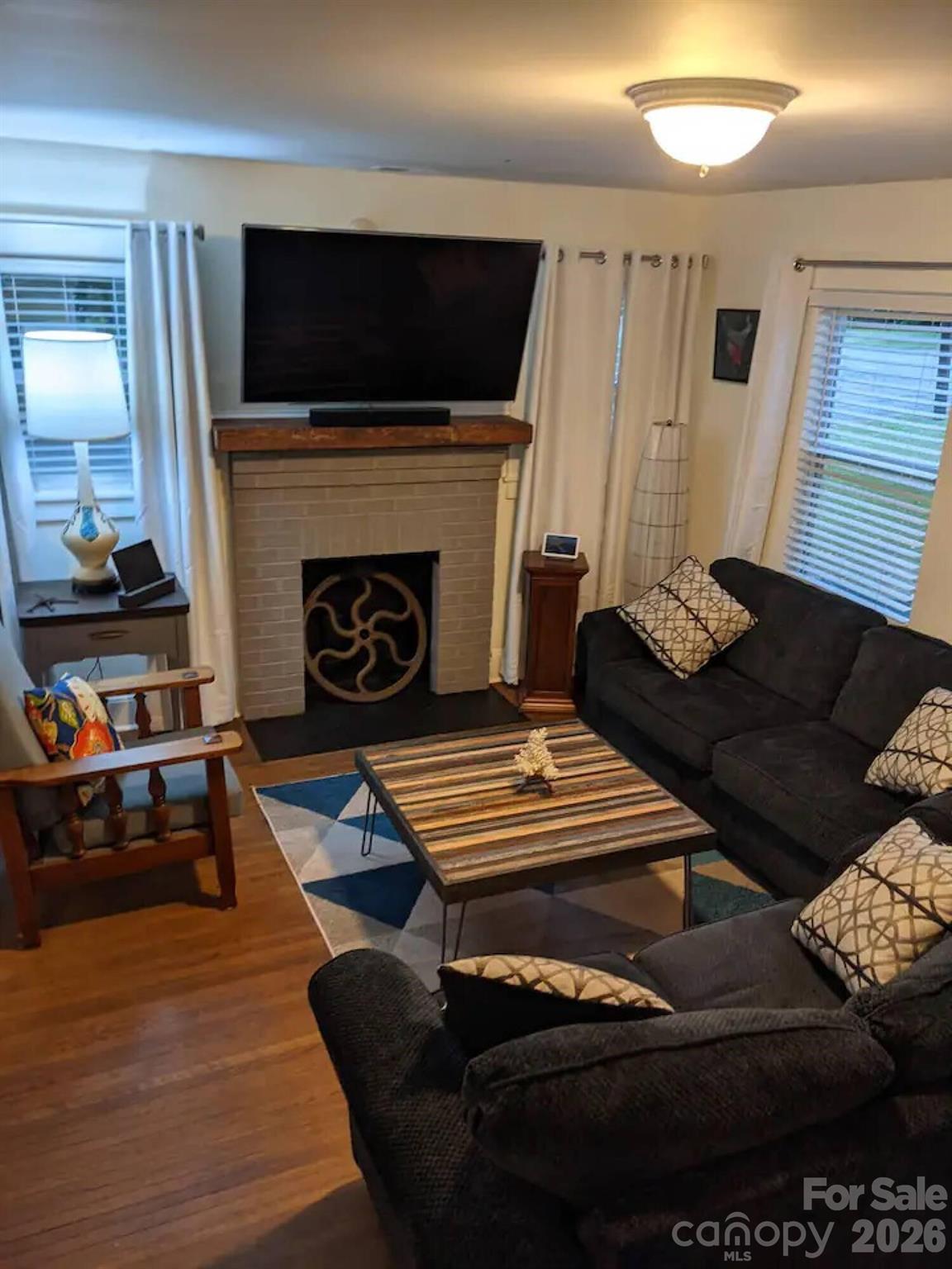 4033 West Tyvola Road Charlotte, NC 28208 - Photo 6 of 48 a living room with furniture and a fireplace