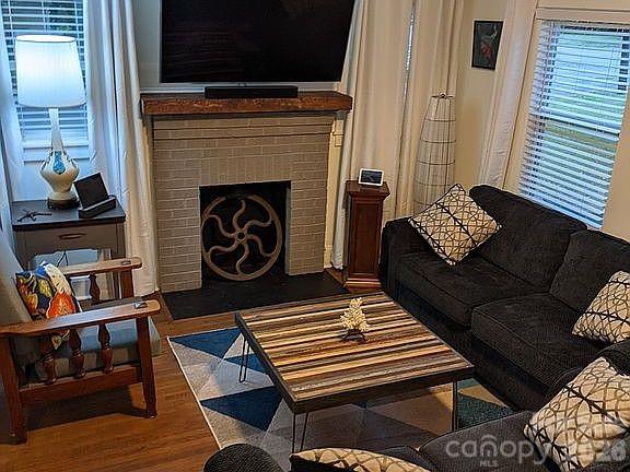4033 West Tyvola Road Charlotte, NC 28208 - Photo 7 of 48 a living room with furniture and a fireplace