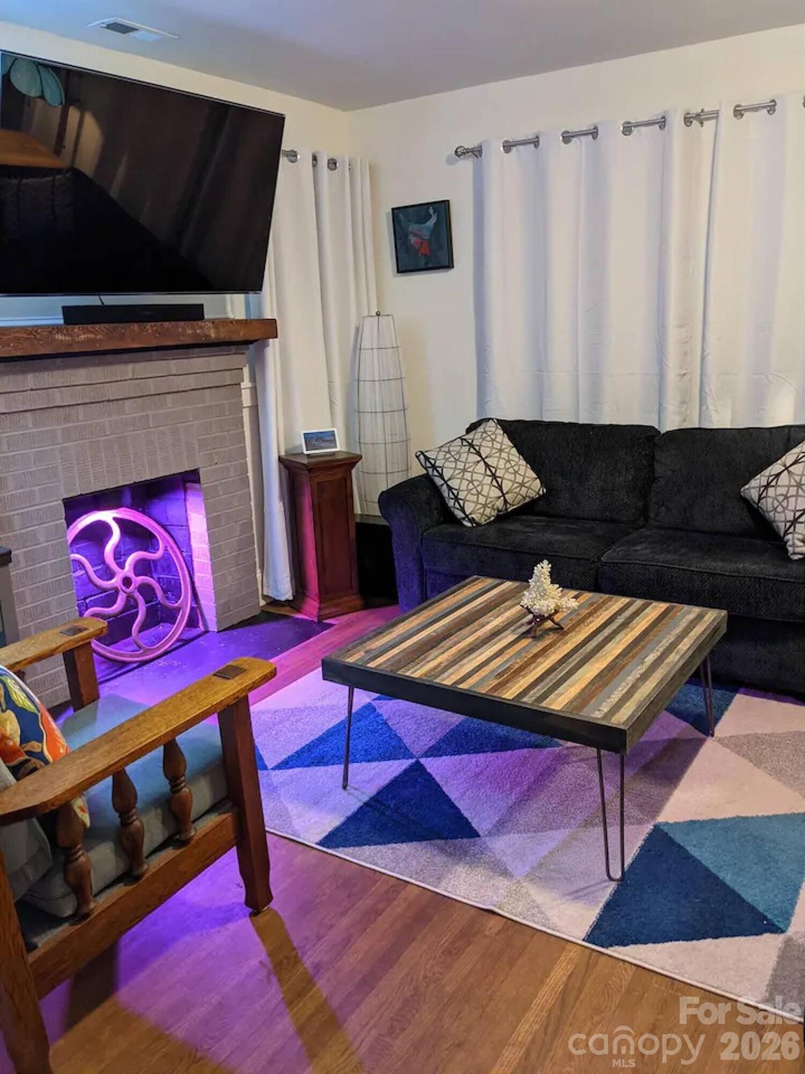 4033 West Tyvola Road Charlotte, NC 28208 - Photo 8 of 48 a living room with furniture and a flat screen tv