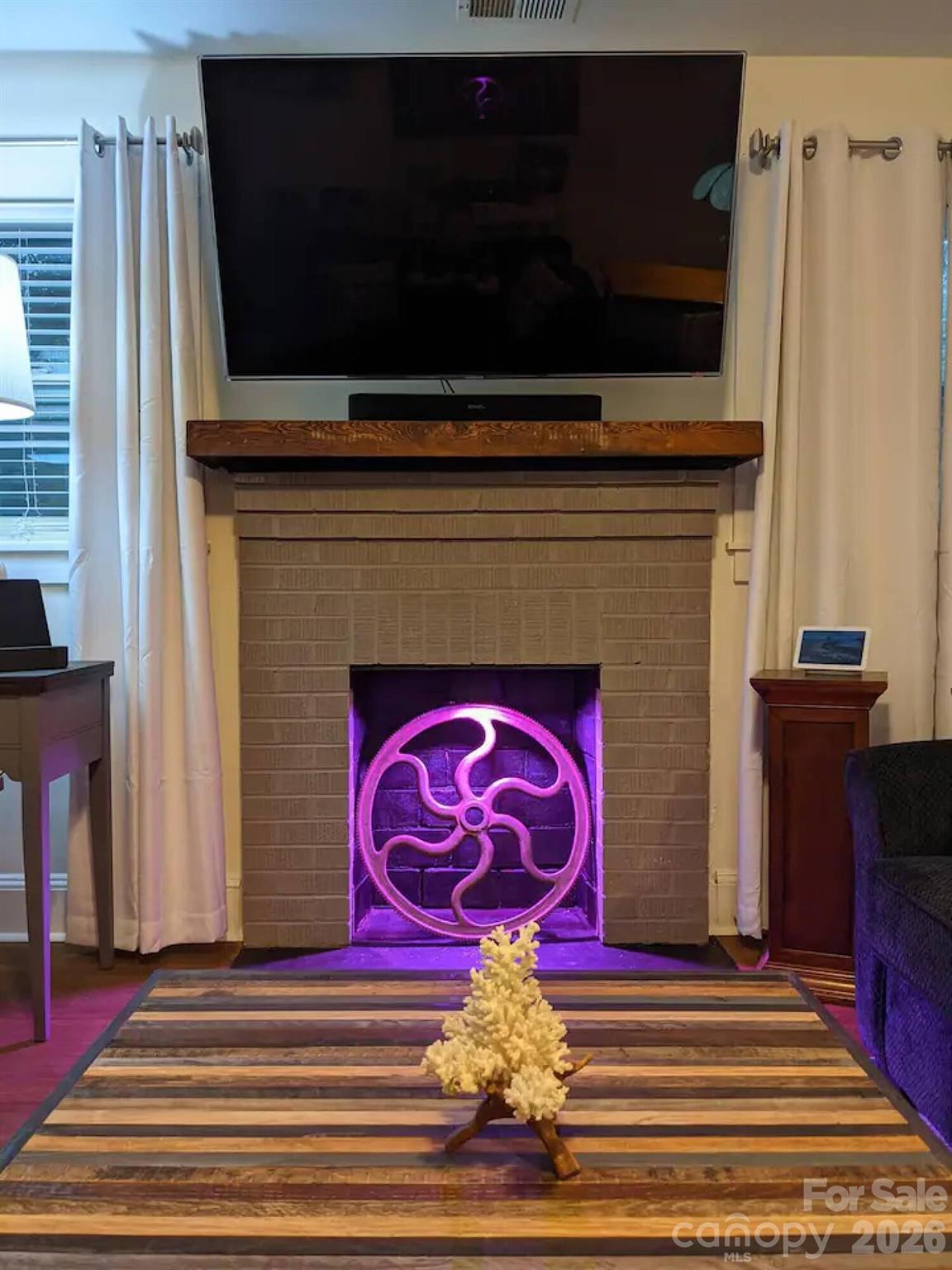 4033 West Tyvola Road Charlotte, NC 28208 - Photo 10 of 48 a front view of a fireplace with wooden floor