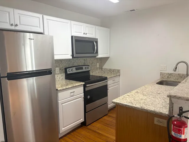 a kitchen with a refrigerator sink and microwave