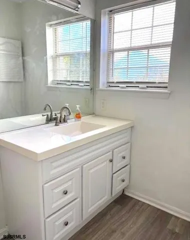 a bathroom with a sink and a window