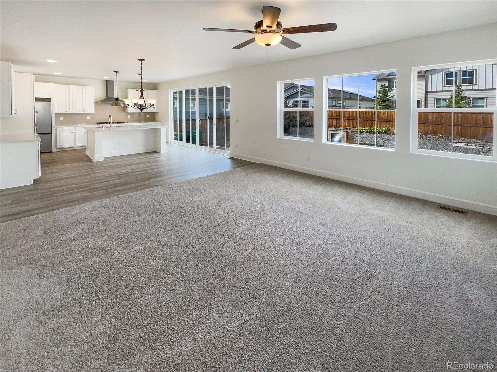 27895 East 7th Place Aurora, CO 80018 - Photo 12 of 35 a view of an empty room with kitchen and window