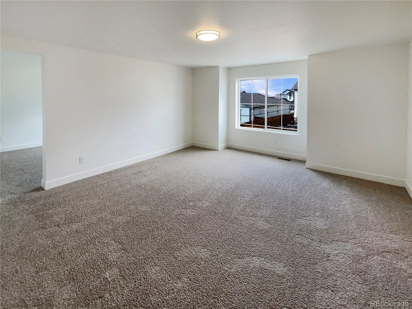 27895 East 7th Place Aurora, CO 80018 - Photo 17 of 35 a view of an empty room with a window