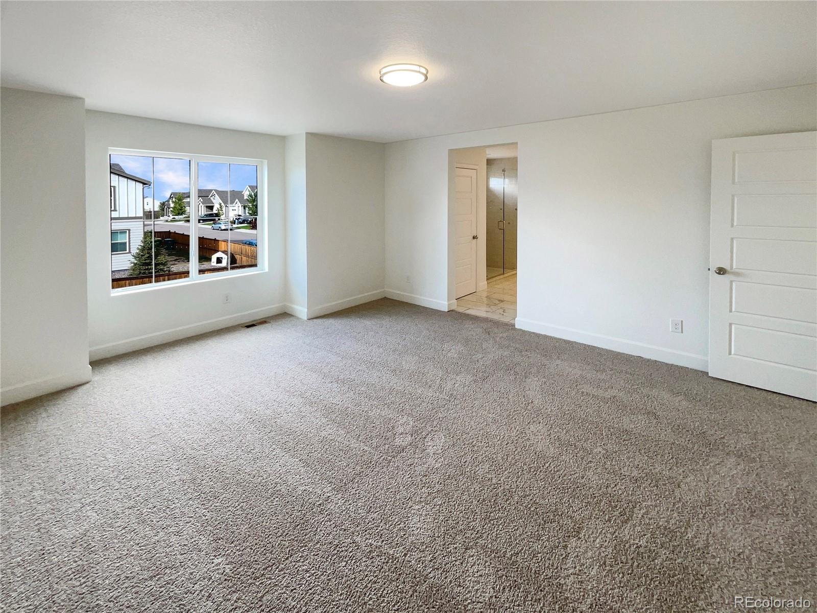 27895 East 7th Place Aurora, CO 80018 - Photo 18 of 35 a view of an empty room with a window