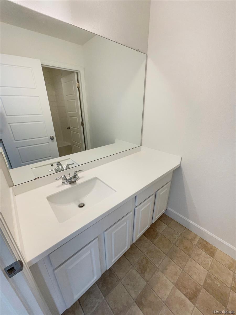 27895 East 7th Place Aurora, CO 80018 - Photo 24 of 35 a bathroom with a sink and a mirror