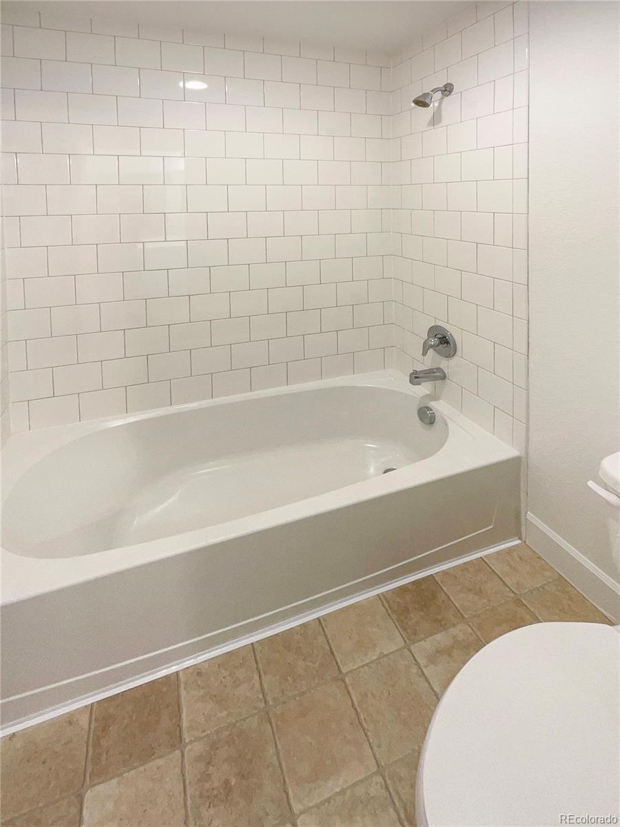 27895 East 7th Place Aurora, CO 80018 - Photo 25 of 35 a bathroom with a bathtub and a toilet