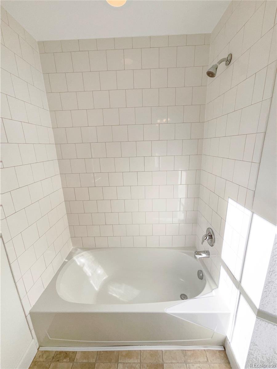 27895 East 7th Place Aurora, CO 80018 - Photo 31 of 35 a bathroom with a bathtub