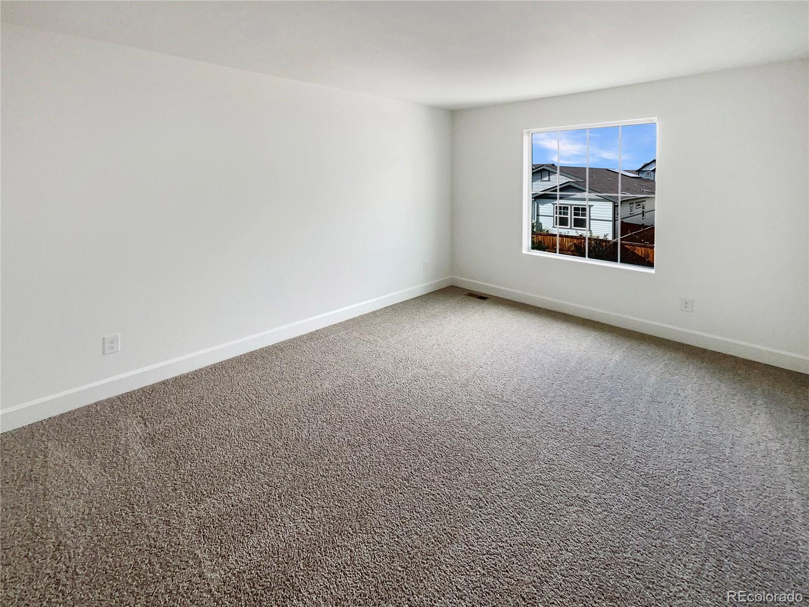 27895 East 7th Place Aurora, CO 80018 - Photo 5 of 35 an empty room with windows and fireplace