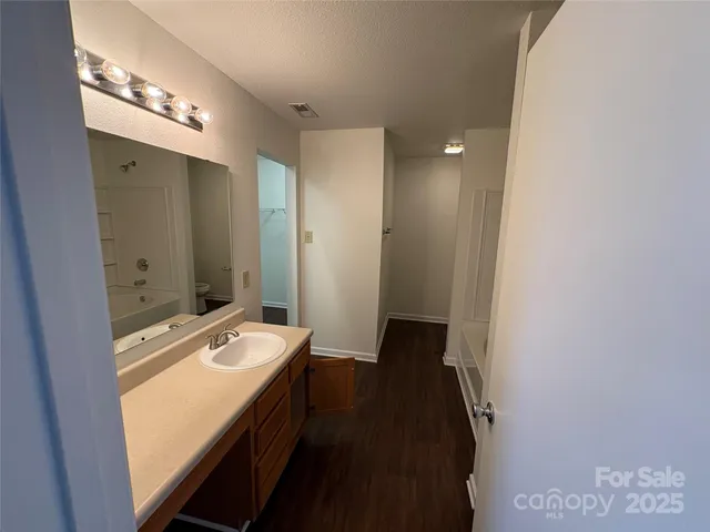 a bathroom with a double vanity sink and mirror