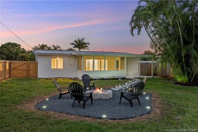 a view of a house with backyard porch and sitting area