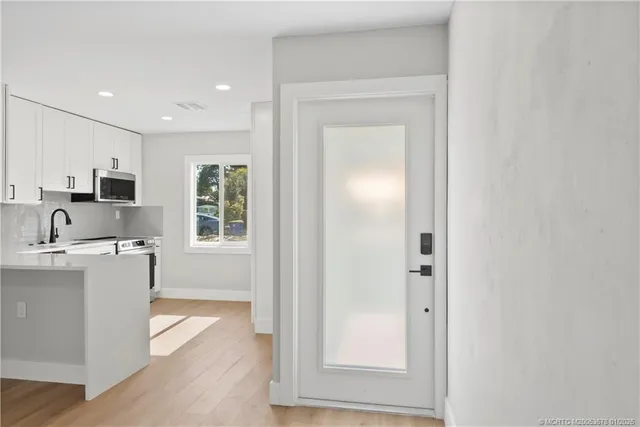 a living room with stainless steel appliances granite countertop furniture and a window