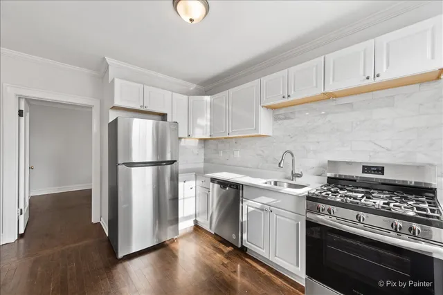a kitchen with a stove a refrigerator and a sink