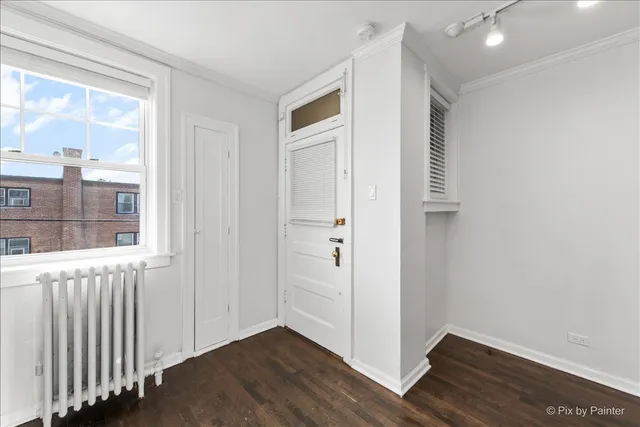 a view of an entryway with wooden floor