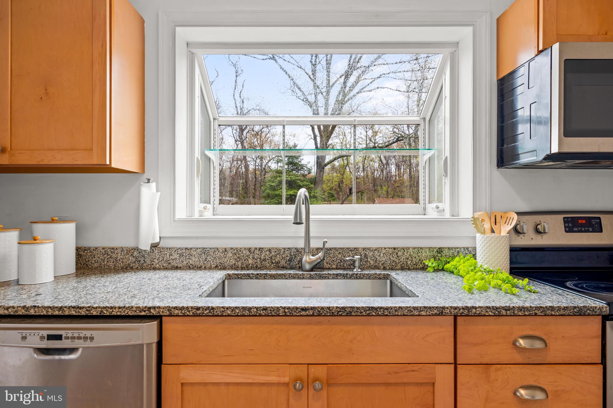 100 Prospect Road Glen Burnie, MD 21060 - Photo 11 of 26 a kitchen with granite countertop a sink and a window