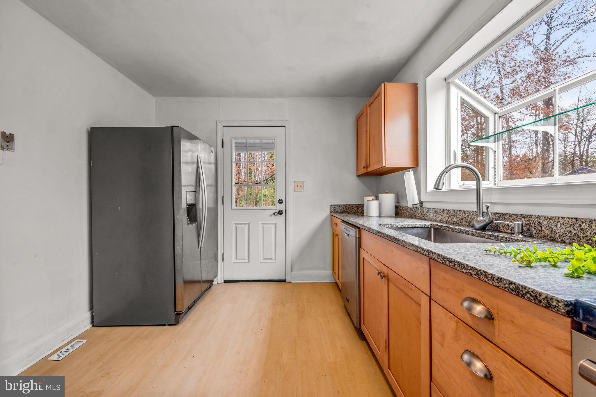 100 Prospect Road Glen Burnie, MD 21060 - Photo 12 of 26 a kitchen with granite countertop a sink stove and cabinets
