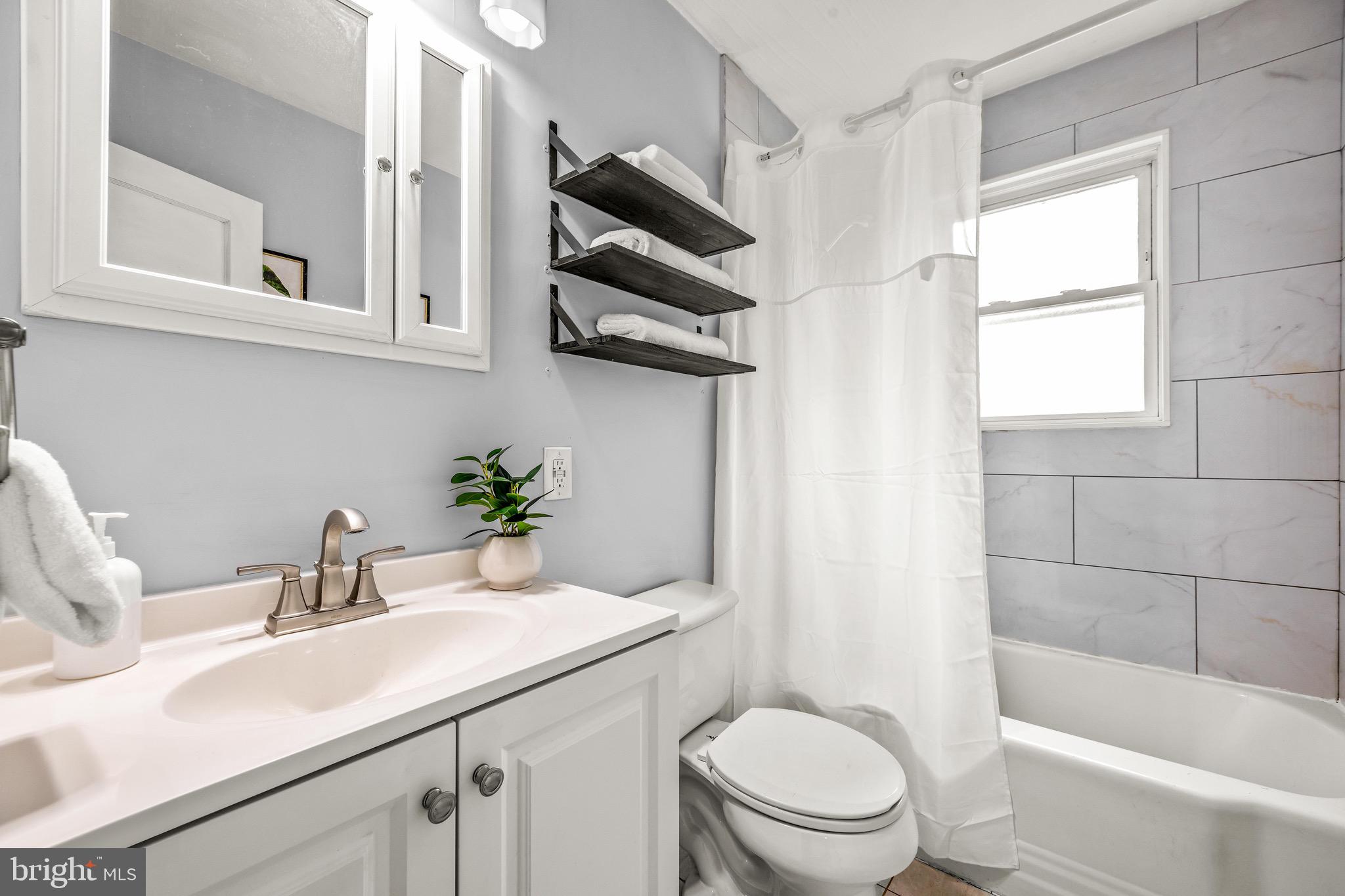 100 Prospect Road Glen Burnie, MD 21060 - Photo 17 of 26 a bathroom with a sink a toilet and shower