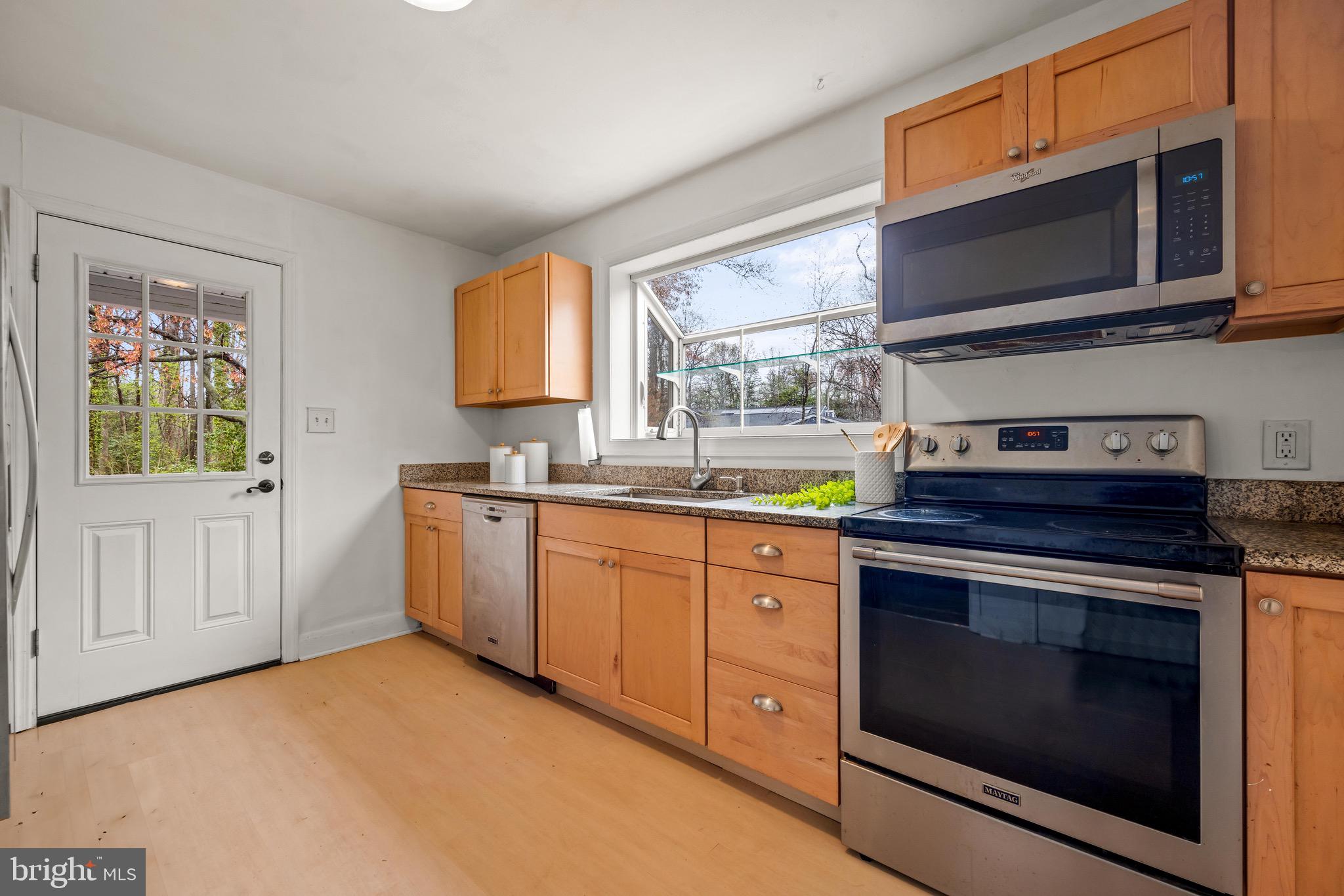 100 Prospect Road Glen Burnie, MD 21060 - Photo 10 of 26 a kitchen with stainless steel appliances granite countertop a stove microwave and sink