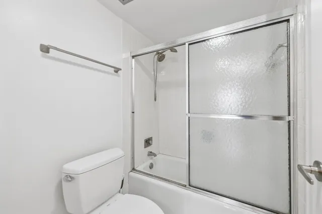 a bathroom with a shower and a toilet