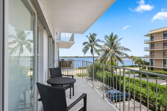 a view of a balcony with lake view and a potted plant