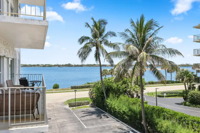a view of a house with a yard and potted plants