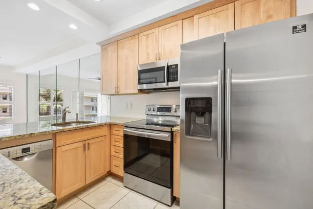 a kitchen with a refrigerator sink and microwave