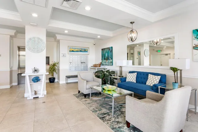 a living room with furniture kitchen view and a large window