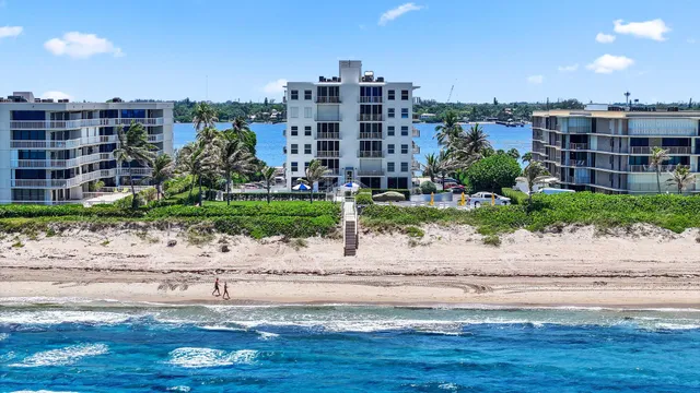 a view of a tall building next to a yard
