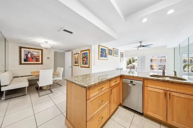 a kitchen with granite countertop a sink and cabinets