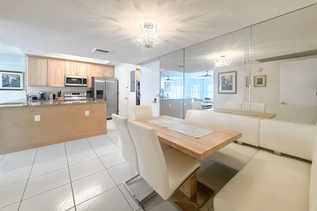 a large kitchen with kitchen island a stove a sink dishwasher and white cabinets with wooden floor