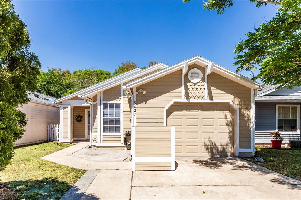 5427 Pullman Drive Orlando, FL 32812 - Photo 1 of 1 a front view of a house with a yard