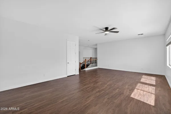 a spacious bedroom with a bed a couch and a flat screen television