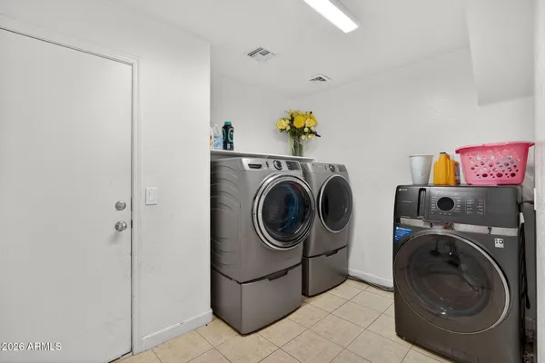 a view of a house with a backyard porch and sitting area