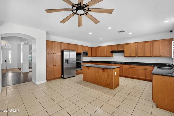 a kitchen with stainless steel appliances granite countertop a sink counter space cabinets and a window
