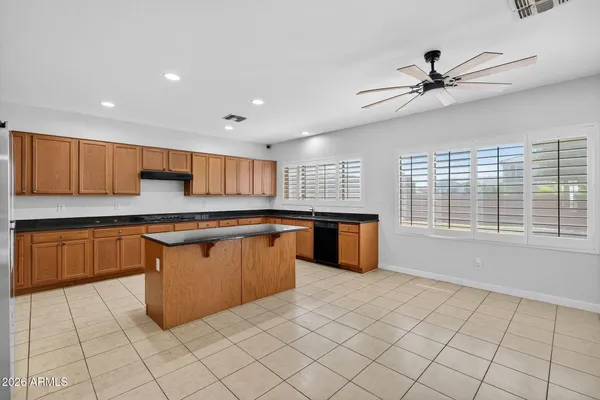 a kitchen with granite countertop a sink and cabinets